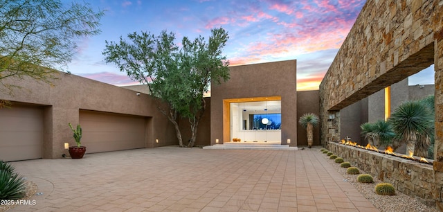 southwest-style home featuring a garage