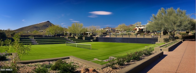 view of community with a mountain view and tennis court