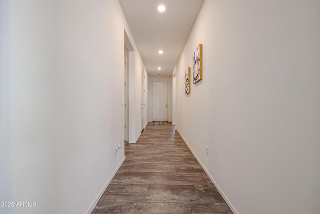 hallway with hardwood / wood-style flooring