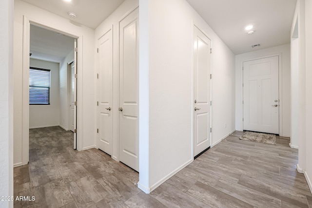 corridor with light hardwood / wood-style flooring