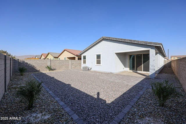 back of property featuring central AC and a patio