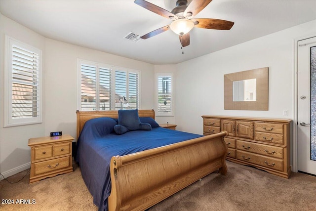 bedroom with ceiling fan and light carpet