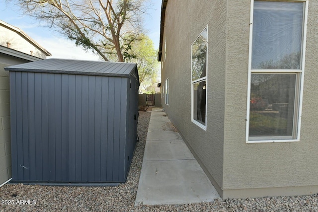 3062 E Cullumber St, Gilbert, AZ 85234 - view of property exterior featuring a storage shed, fence, stucco siding, and an outdoor structure