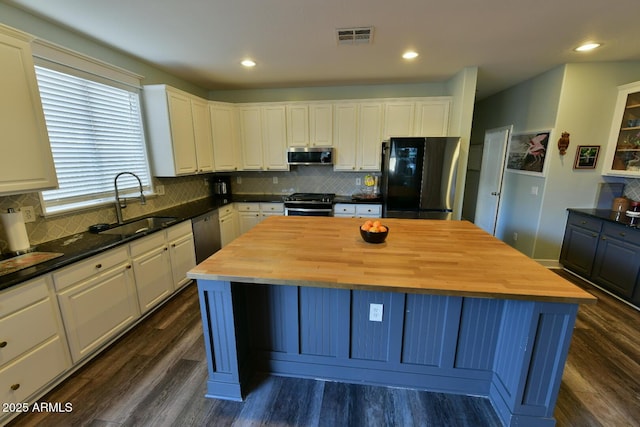 3062 E Cullumber St, Gilbert, AZ 85234 - kitchen featuring appliances with stainless steel finishes, butcher block counters, white cabinets, and a kitchen island
