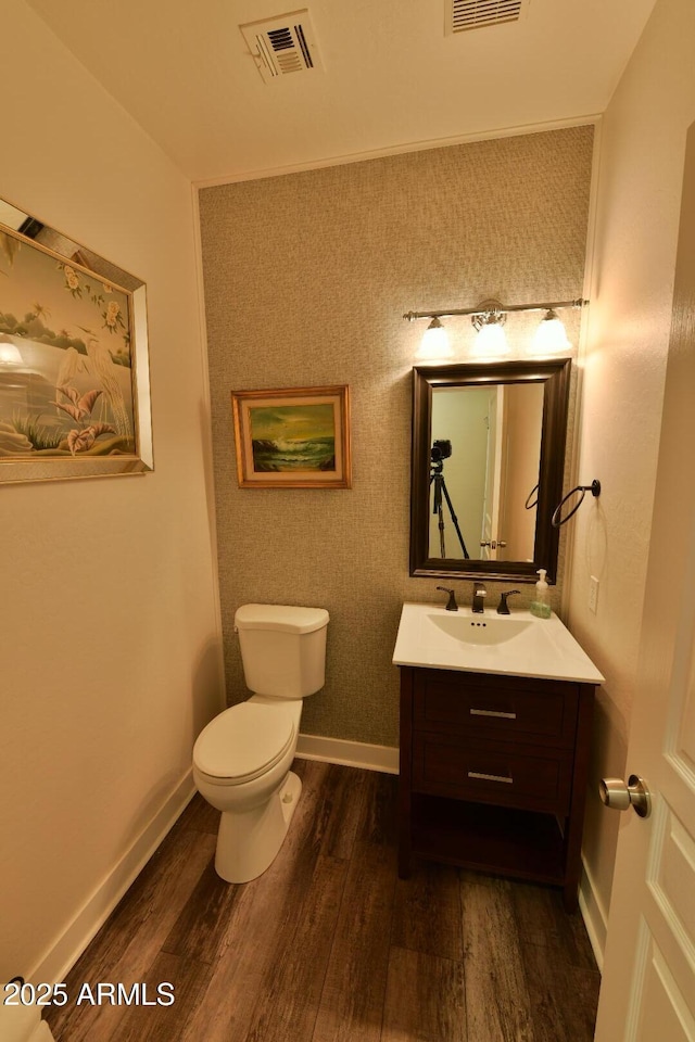 3062 E Cullumber St, Gilbert, AZ 85234 - half bathroom featuring visible vents, toilet, vanity, wood finished floors, and baseboards