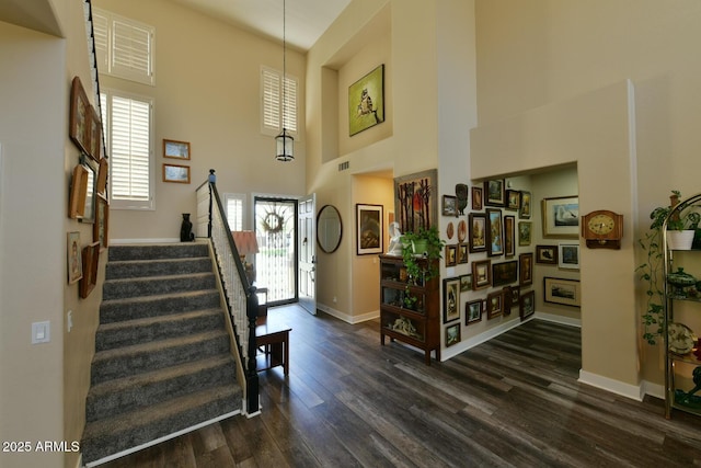 3062 E Cullumber St, Gilbert, AZ 85234 - foyer entrance featuring dark wood-style floors, visible vents, stairway, a towering ceiling, and baseboards