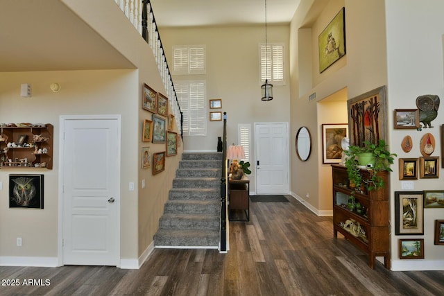 3062 E Cullumber St, Gilbert, AZ 85234 - foyer with visible vents, a high ceiling, stairway, and dark wood-style flooring