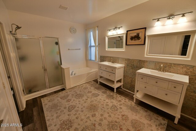 3062 E Cullumber St, Gilbert, AZ 85234 - full bath featuring two vanities, a stall shower, a sink, wood finished floors, and a bath