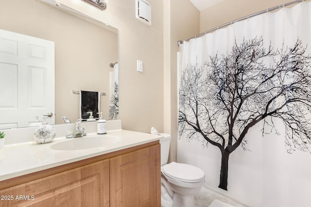 bathroom featuring vanity and toilet