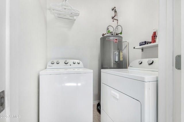 laundry area with washer and clothes dryer and electric water heater