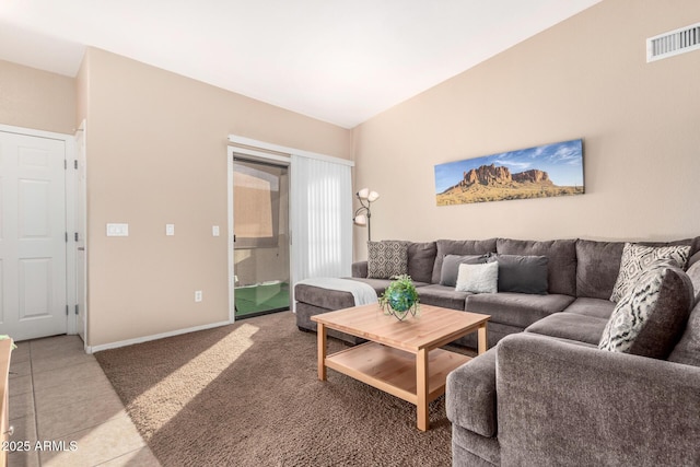 living room featuring lofted ceiling and tile patterned floors