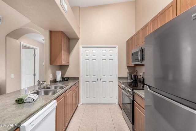 kitchen featuring sink, light tile patterned floors, and appliances with stainless steel finishes