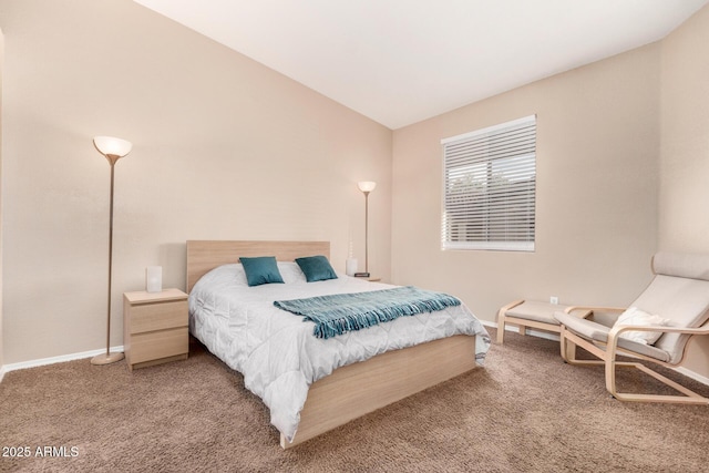 bedroom featuring lofted ceiling and carpet flooring