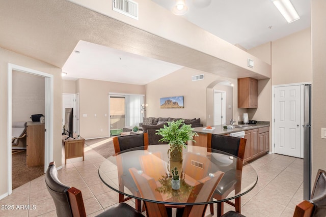 tiled dining room with sink