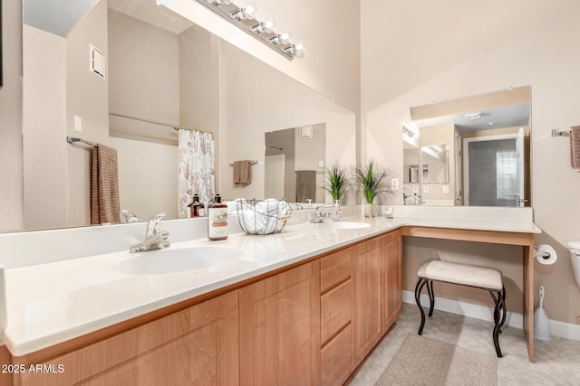 bathroom featuring vanity and toilet