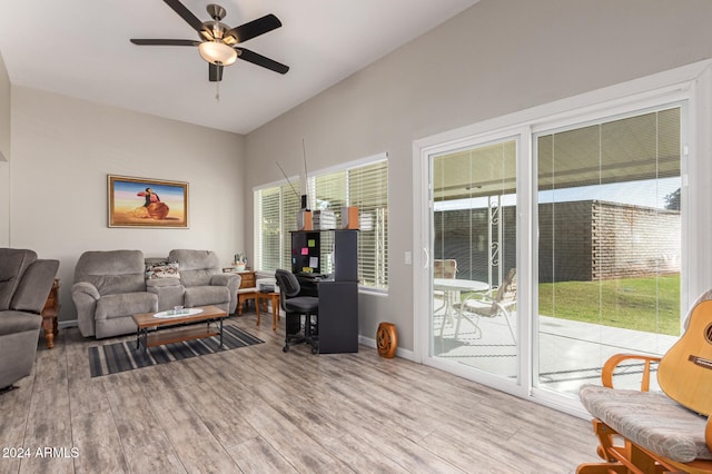 living room with ceiling fan, a healthy amount of sunlight, and light wood-type flooring