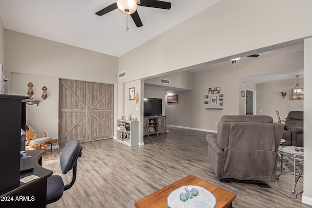 living room featuring hardwood / wood-style floors, ceiling fan, and lofted ceiling