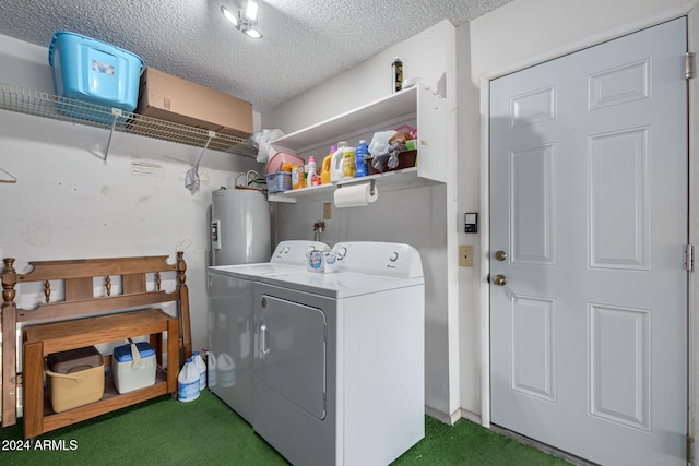 laundry area featuring electric water heater, washer and dryer, a textured ceiling, and dark colored carpet