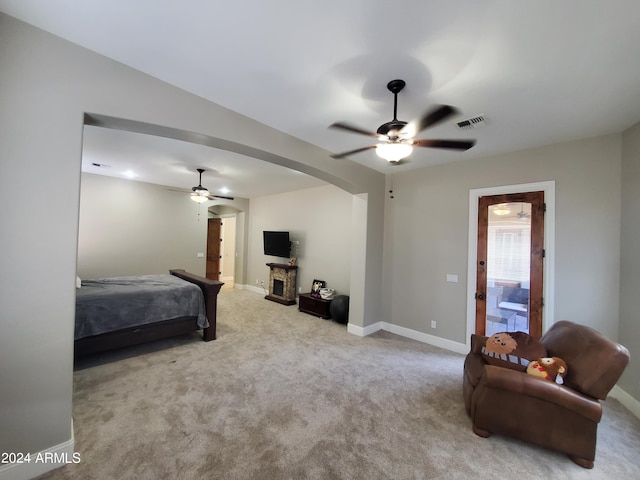 bedroom with ceiling fan and light colored carpet