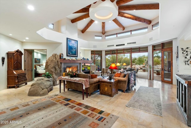 living room featuring beamed ceiling and a high ceiling