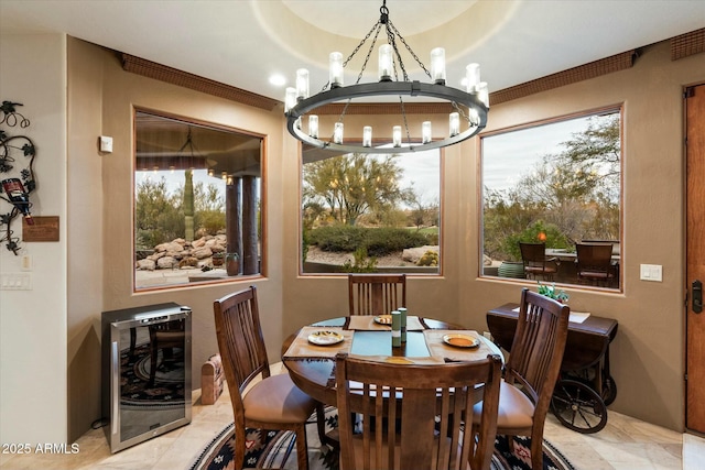 dining room featuring ornamental molding, beverage cooler, and a chandelier