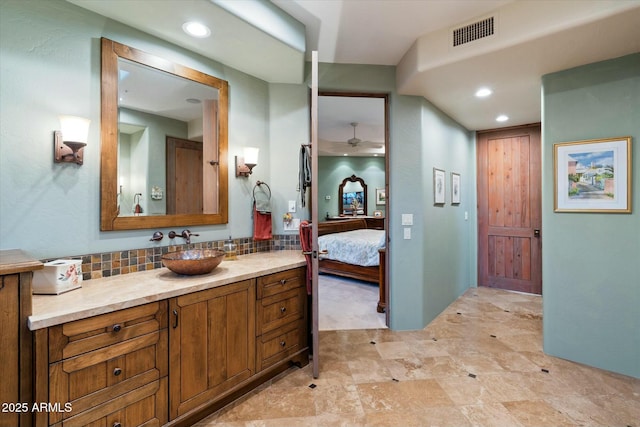 bathroom with vanity and backsplash