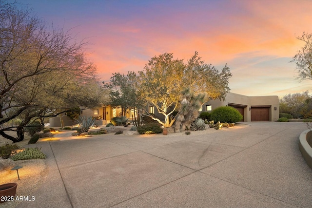 pueblo revival-style home with a garage