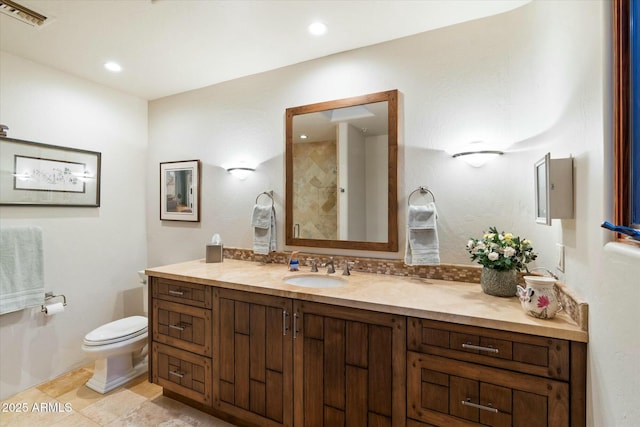 bathroom featuring tile patterned flooring, vanity, and toilet