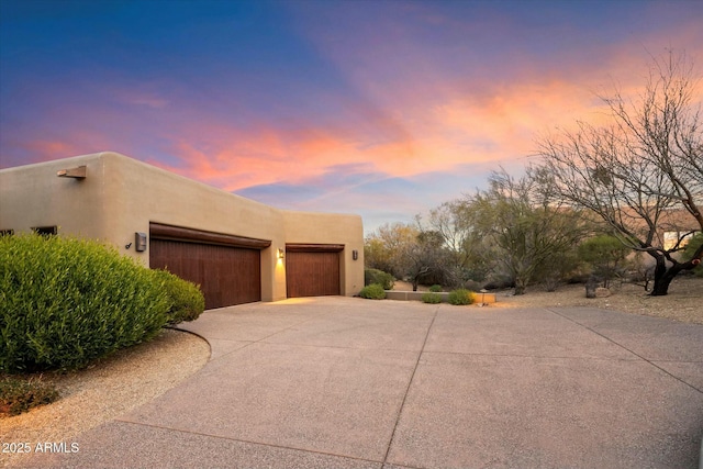 property exterior at dusk with a garage