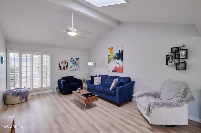 living room featuring baseboards, lofted ceiling with skylight, ceiling fan, and wood finished floors