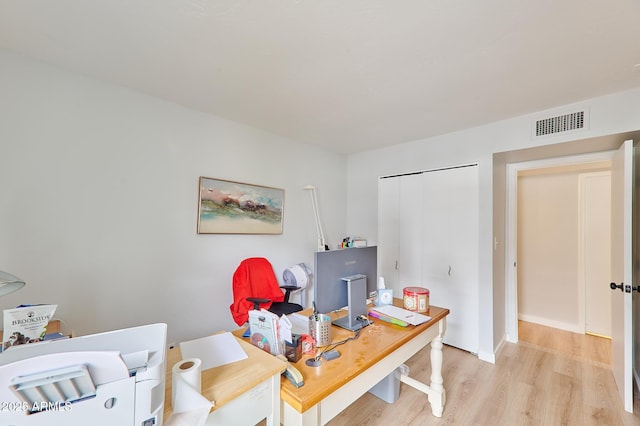 office featuring light wood-style floors, visible vents, and baseboards