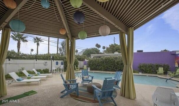 view of patio featuring a fenced backyard and a community pool