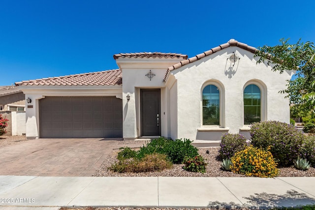 4051 S Galaxy Ln, Mesa, AZ 85212 - mediterranean / spanish-style house with stucco siding, a garage, a tile roof, and decorative driveway