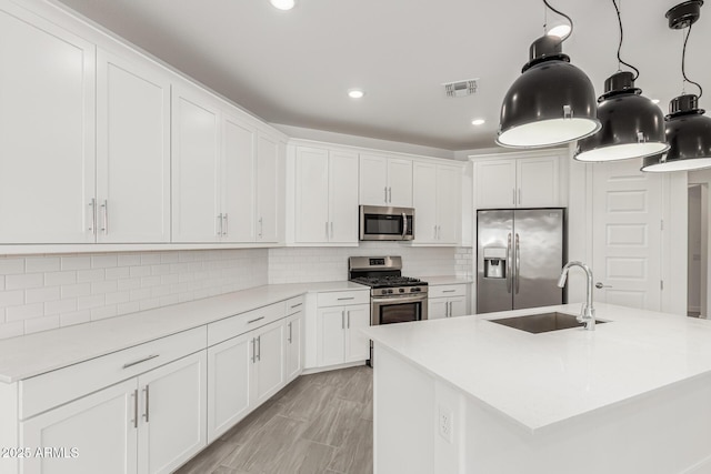 4051 S Galaxy Ln, Mesa, AZ 85212 - kitchen with stainless steel appliances, a sink, white cabinets, light countertops, and recessed lighting