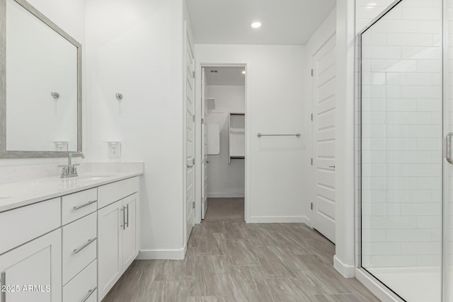 4051 S Galaxy Ln, Mesa, AZ 85212 - full bathroom with vanity, a stall shower, a spacious closet, baseboards, and recessed lighting
