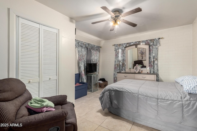 bedroom with ceiling fan and light tile patterned floors