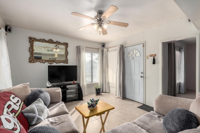 living room with light tile patterned floors and ceiling fan