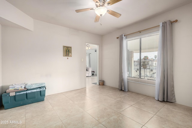 empty room featuring ceiling fan and light tile patterned floors