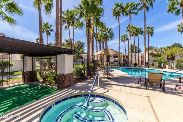 pool featuring a patio area, a hot tub, and fence