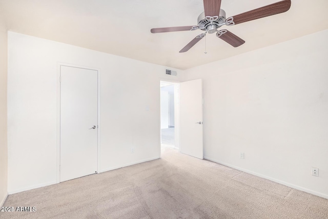 unfurnished bedroom featuring a ceiling fan, carpet, visible vents, and baseboards