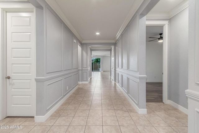 hall with baseboards, ornamental molding, light tile patterned floors, and recessed lighting