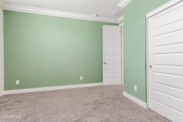 unfurnished bedroom with crown molding, baseboards, carpet, and visible vents