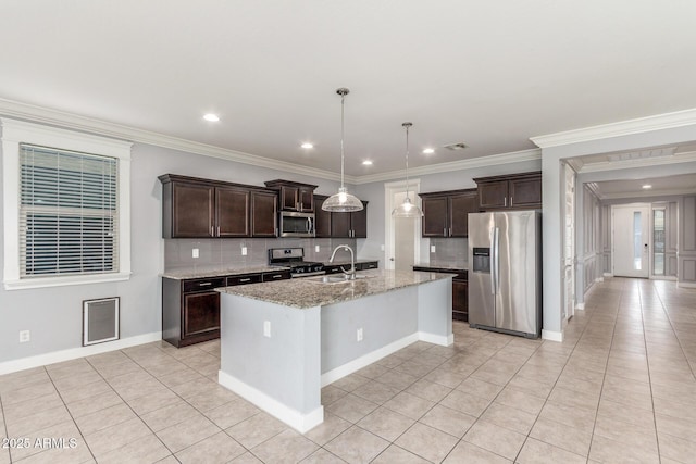 kitchen with a sink, light tile patterned flooring, dark brown cabinets, and stainless steel appliances