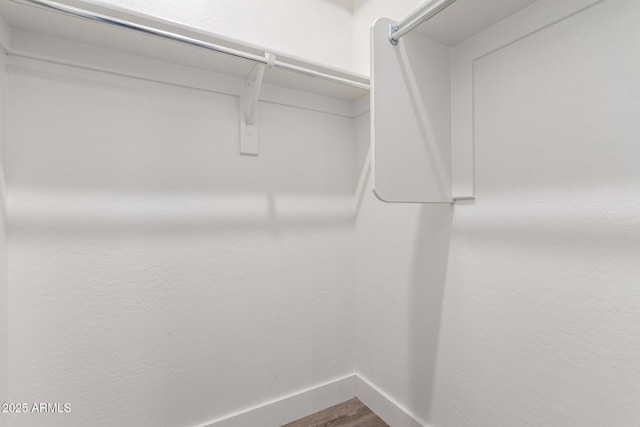 walk in closet featuring dark wood-type flooring