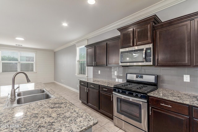 kitchen featuring a sink, appliances with stainless steel finishes, backsplash, and ornamental molding