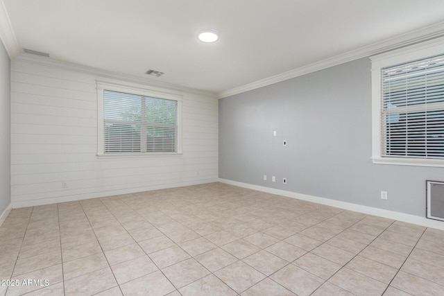 unfurnished room featuring crown molding, baseboards, and visible vents