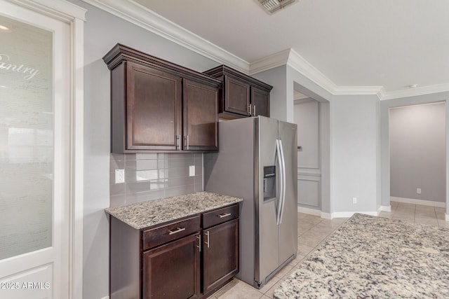 kitchen featuring dark brown cabinetry, visible vents, stainless steel fridge with ice dispenser, light stone counters, and ornamental molding