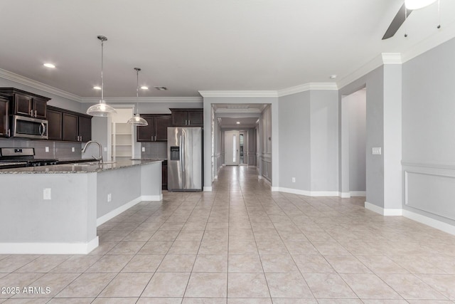 kitchen with crown molding, light stone countertops, stainless steel appliances, and dark brown cabinetry