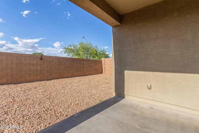 view of patio featuring fence