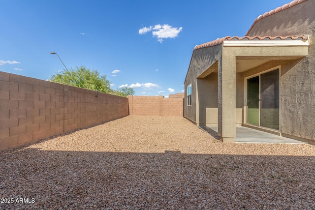 view of yard with a fenced backyard and a patio area